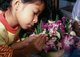 Thailand: Young girl making a krathong, Loy Krathong Festival, Chiang Mai