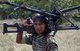 Sri Lanka: Female LTTE (Liberation Tigers of Tamil Eelam) soldier posing for LTTE publicity photograph with a heavy machine gun, c. 2008.